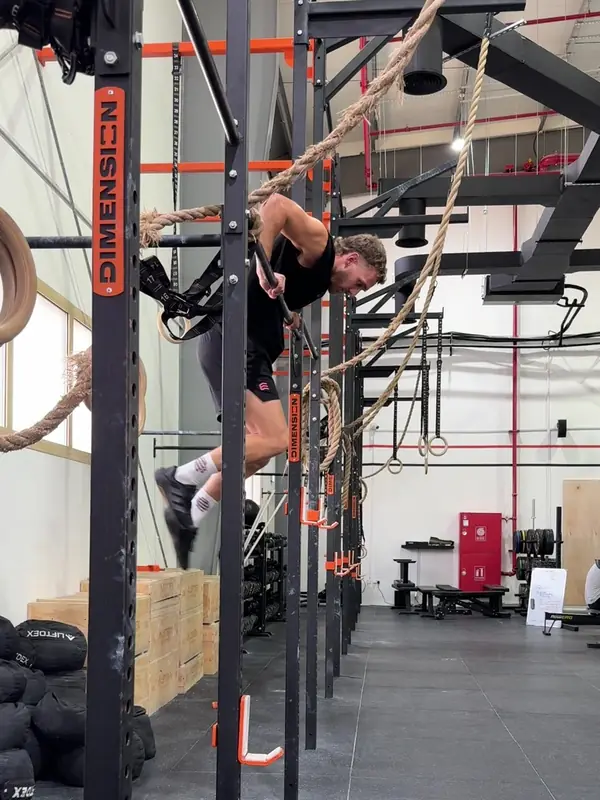 Tom turning over the bar, chest moving over it