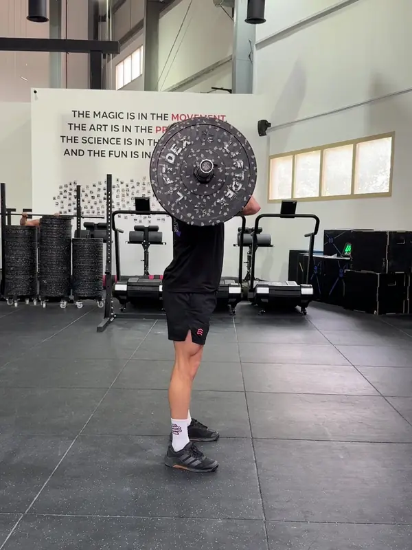 Tom standing with the bar in the front rack