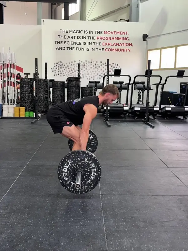 Tom pushing the bar off the floor with a flat back