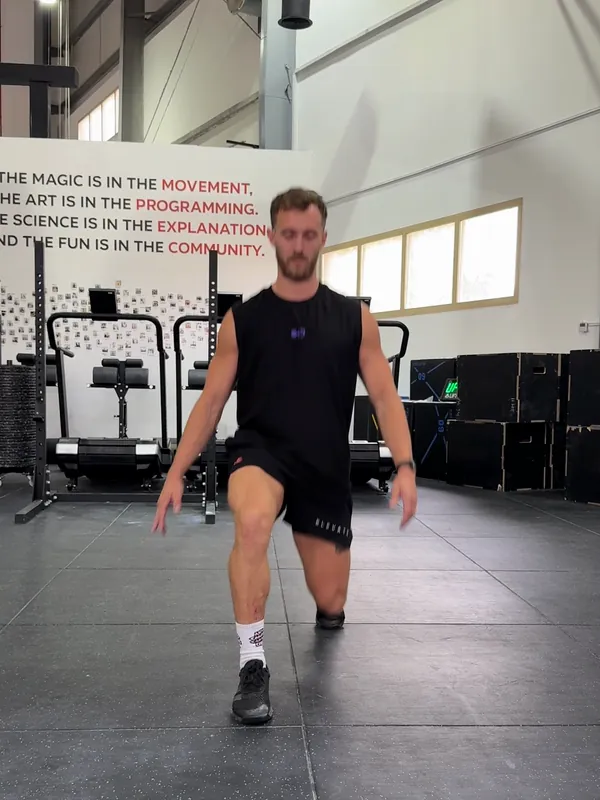 Coach Tom rising out of the bottom of a lunge, pushing through his front foot